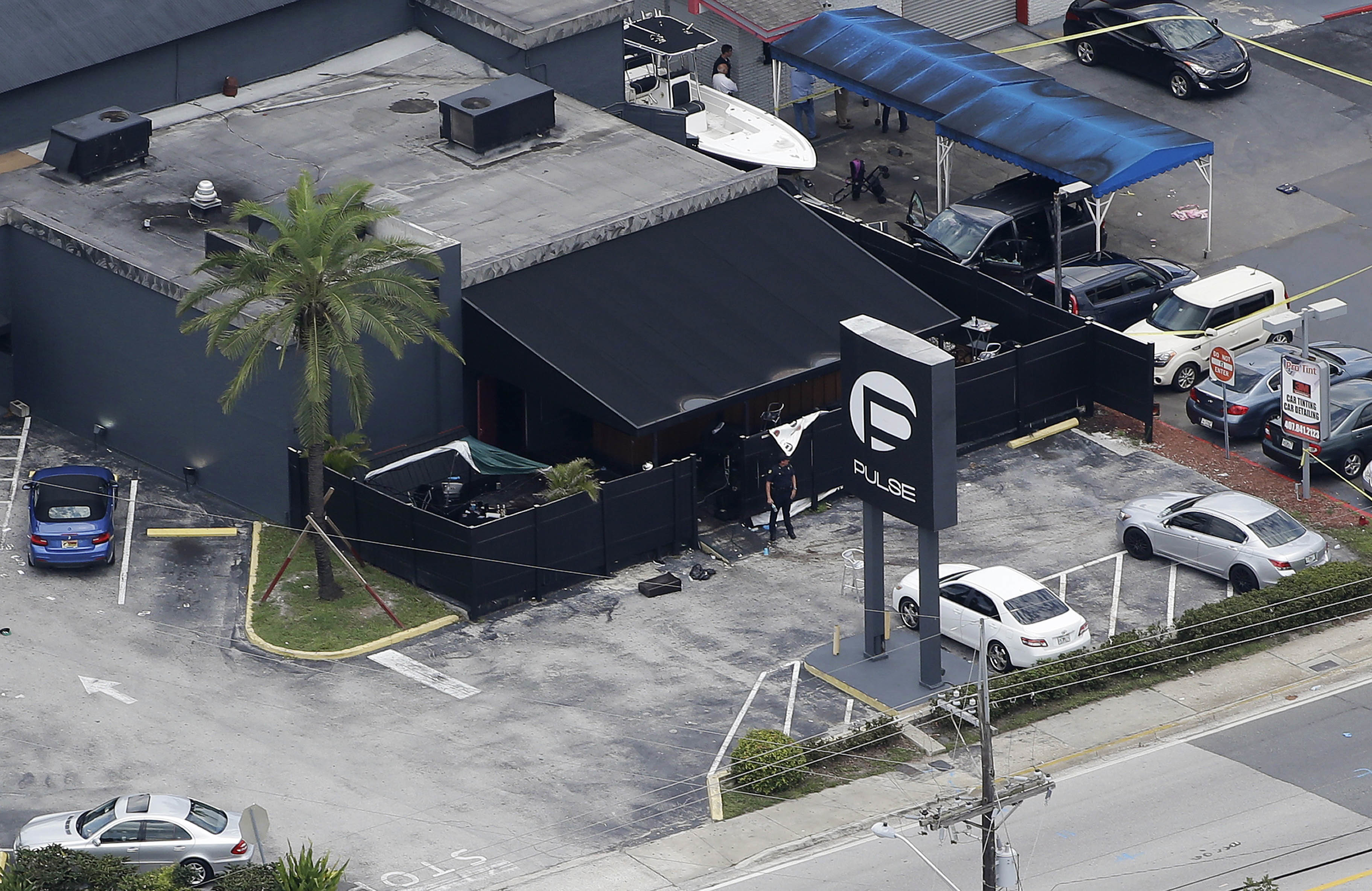 FILE - In this June 12, 2016 file photo, law enforcement officials work at the Pulse gay nightclub in Orlando, Fla., following the a mass shooting. Audio recordings of 911 calls released Tuesday, Aug. 30, by the Orange County Sheriff's Office show mounting frustration by friends and family members who were texting, calling and video-chatting with trapped patrons of the Pulse nightclub where Omar Mateen opened fire in June. A U.S. law enforcement official says the FBI has arrested the wife of the Orlando nightclub shooter. The official says Noor Salman was taken into custody Monday, Jan. 16, 2017, in the San Francisco area and is due in court Tuesday in California. She's facing charges in Florida including obstruction of justice.