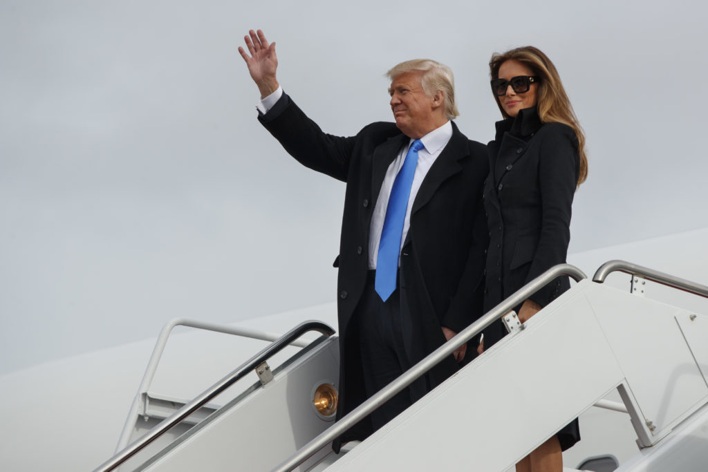 President-elect Donald Trump, accompanied by his wife Melania Trump, waves as they arrive at Andrews Air Force Base, Thursday, Jan. 19, 2017, in Andrews Air Force Base, Md.