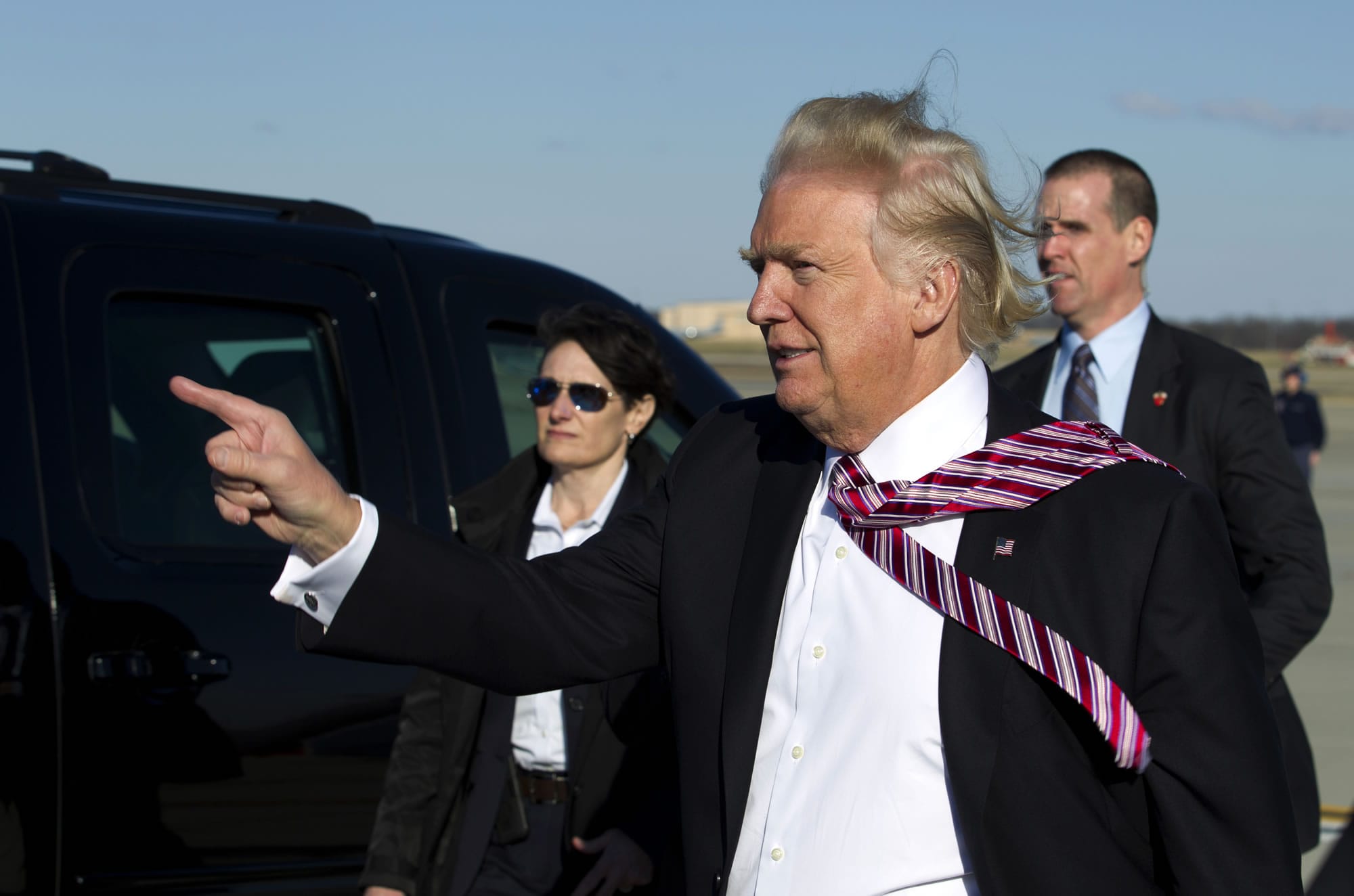 President Donald Trump points to guests upon his arrival at Andrews Air Force One, Md., Thursday, Jan. 26, 2017. Trump is returning from Philadelphia after speaking at the House and Senate GOP lawmakers at their annual policy retreat.