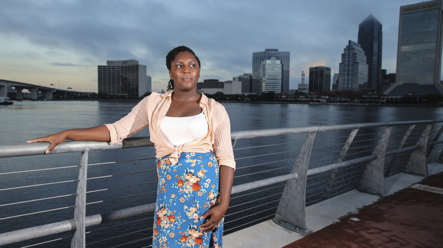 Asia Howard poses for a photo at St. Johns River Park at sunrise, in Jacksonville, Fla. Howard was stuck in mostly retail and fast-food jobs after graduating high school, unable to get a job in banking, a profession she prized for its steady hours.