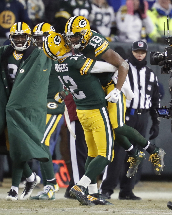 Green Bay Packers quarterback Aaron Rodgers (12) celebrates with wide receiver Randall Cobb (18) after throwing a touchdown pass to Cobb during the first half of an NFC wild-card NFL football game, Sunday, Jan. 8, 2017, in Green Bay, Wis.