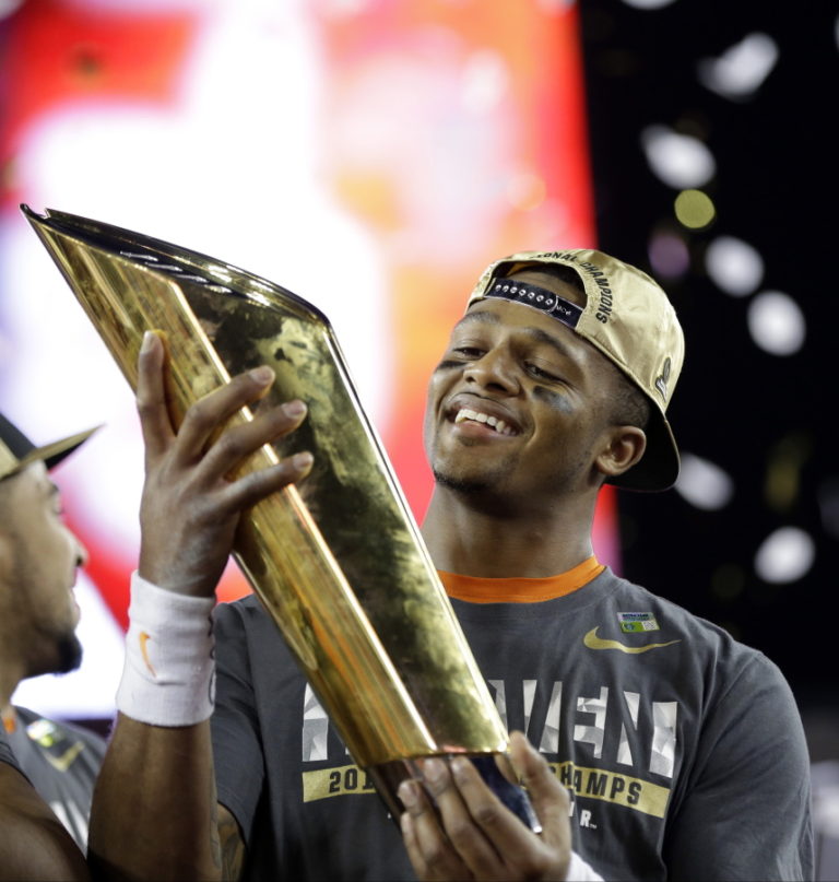 Clemson&#039;s Deshaun Watson holds up the championship trophy after the NCAA college football playoff championship game against Alabama Tuesday, Jan. 10, 2017, in Tampa, Fla. Clemson won 35-31. (AP Photo/David J.