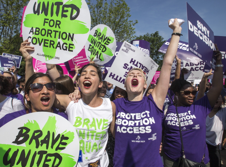Abortion rights activists, from left, Ravina Daphtary of Philadelphia, Morgan Hopkins of Boston, and Alison Turkos of New York City, rejoice in front of the Supreme Court in Washington, as the justices struck down the strict Texas anti-abortion restriction law known as HB2. Even as the 2016 election outcome intensifies America&#039;s abortion debate, a comprehensive new survey released Tuesday, Jan. 17, 2017 by the Guttmacher Institute finds the annual number of abortions in the U.S has dropped to well under 1 million, the lowest level since 1974. (AP Photo/J.