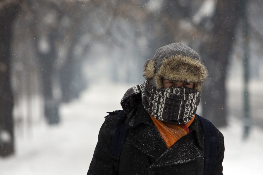 A man walks along a snow covered road in Sarajevo, Bosnia on Monday. Extremely cold weather continued in most of Eastern Europe, with snow blizzards and dangerously low temperatures.
