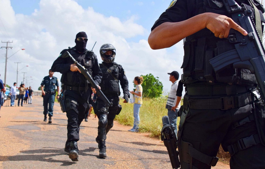 Heavily armed police officers walk outside the Agricultural Penitentiary of Monte Cristo, after  dozens of inmates were killed, in Boa Vista, Roraima state, Brazil, Friday, Jan. 6, 2017. Scores of inmates were slain, some with their hearts and intestines ripped out, during a prison killing spree led by Brazil&#039;s largest gang, authorities said.
