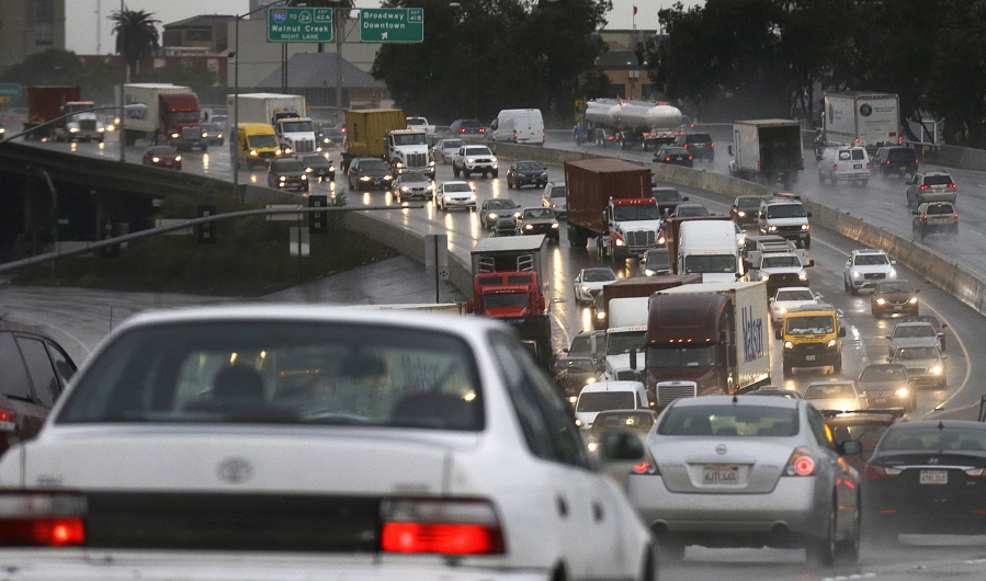 Heavy traffic is seen along Interstate 880 during a rain storm on Wednesday in Oakland, Calif. The San Francisco Bay Area is being hit with a new series of rain storms.