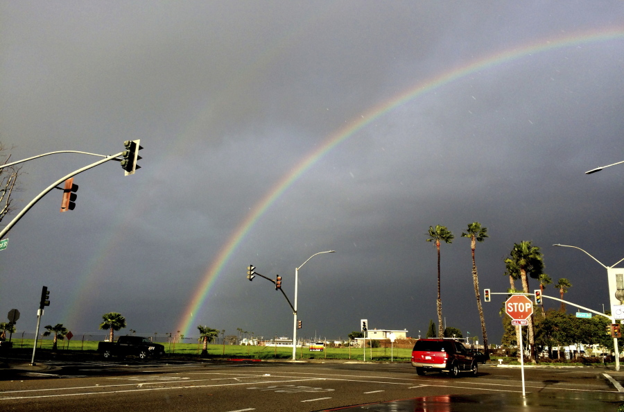 A rainbow appears over Seal Beach, Calif., on Monday. The tail end of a punishing winter storm system lashed California with thunderstorms and severe winds Monday after breaking rainfall records, washing out roads and whipping up enormous waves.