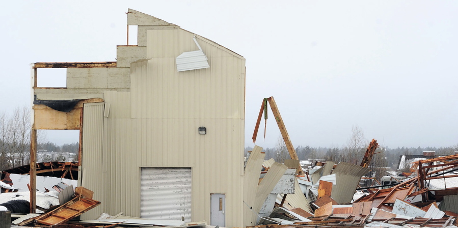 A section of wall remains standing at the KorPine mill building in Bend, Ore., on Jan. 18, 2017. The building collapsed last week when large amounts of snow caused the roof to fall in.