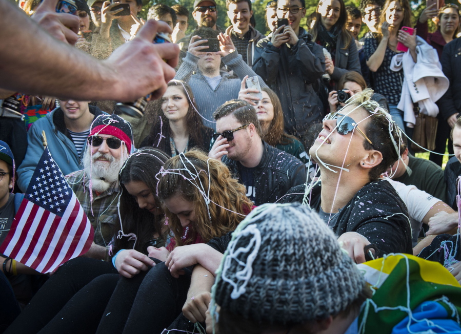 Milo Yiannopoulos, right, is sprayed with Silly String along with UC Davis College Republicans as they re-enact the Nov. 18, 2011, pepper-spraying of students by campus police during a rally on campus Saturday.