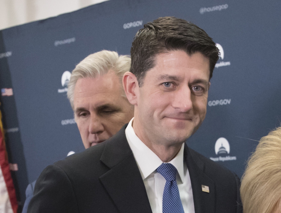 House Speaker Paul Ryan of Wis., accompanied by House Majority Leader Kevin McCarthy of California, leaves a news conference on Capitol Hill in Washington.  (AP Photo/J.