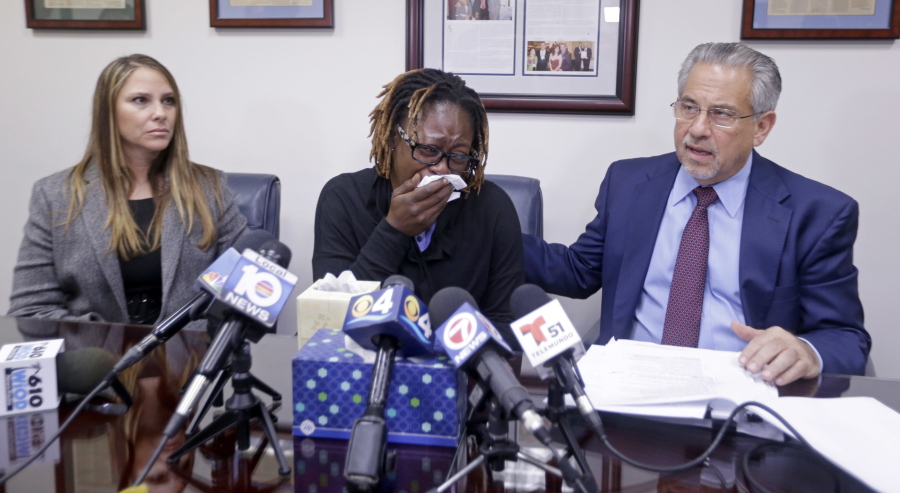 Attorney Howard M. Talenfeld, right, talks to reporters Wednesday as Gina Alexis, center, mother of 14-year-old Nakia Venant, who livestreamed her suicide on Facebook over the weekend, cries and Stacie J. Schmerling, left, looks on, during a news conference in Plantation, Fla.