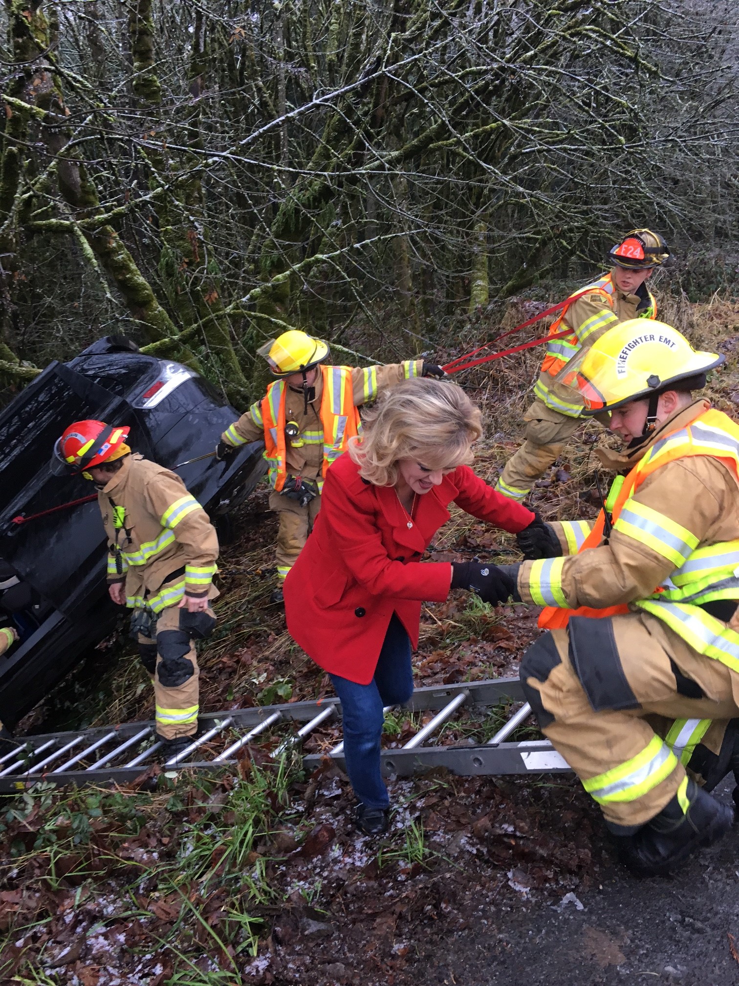 Firefighters rescued a woman and her three children who were trapped in a minivan after it went down an embankment Monday morning.