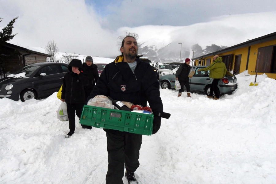 Residents carry food and goods brought by Italian army&#039;s vehicles in the village of Campotosto, in the mountainous region of central Italy that has been struck by a series of quakes since August that destroyed historic centers in dozens of towns and hamlets Thursday.  Rescue workers were met with an eerie silence Thursday when they reached a four-star spa hotel struck by an avalanche in a mountainous earthquake-stricken region of central Italy. At least 30 people were missing, including at least two children, authorities said.
