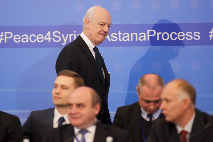 U.N. Special Envoy for Syria Staffan de Mistura, back, arrives to talks on Syrian peace at a hotel hall in Astana, Kazakhstan, on Monday. The talks are the latest attempt to forge a political settlement to end a war that has by most estimates killed more than 400,000 people since March 2011 and displaced more than half the country&#039;s population.