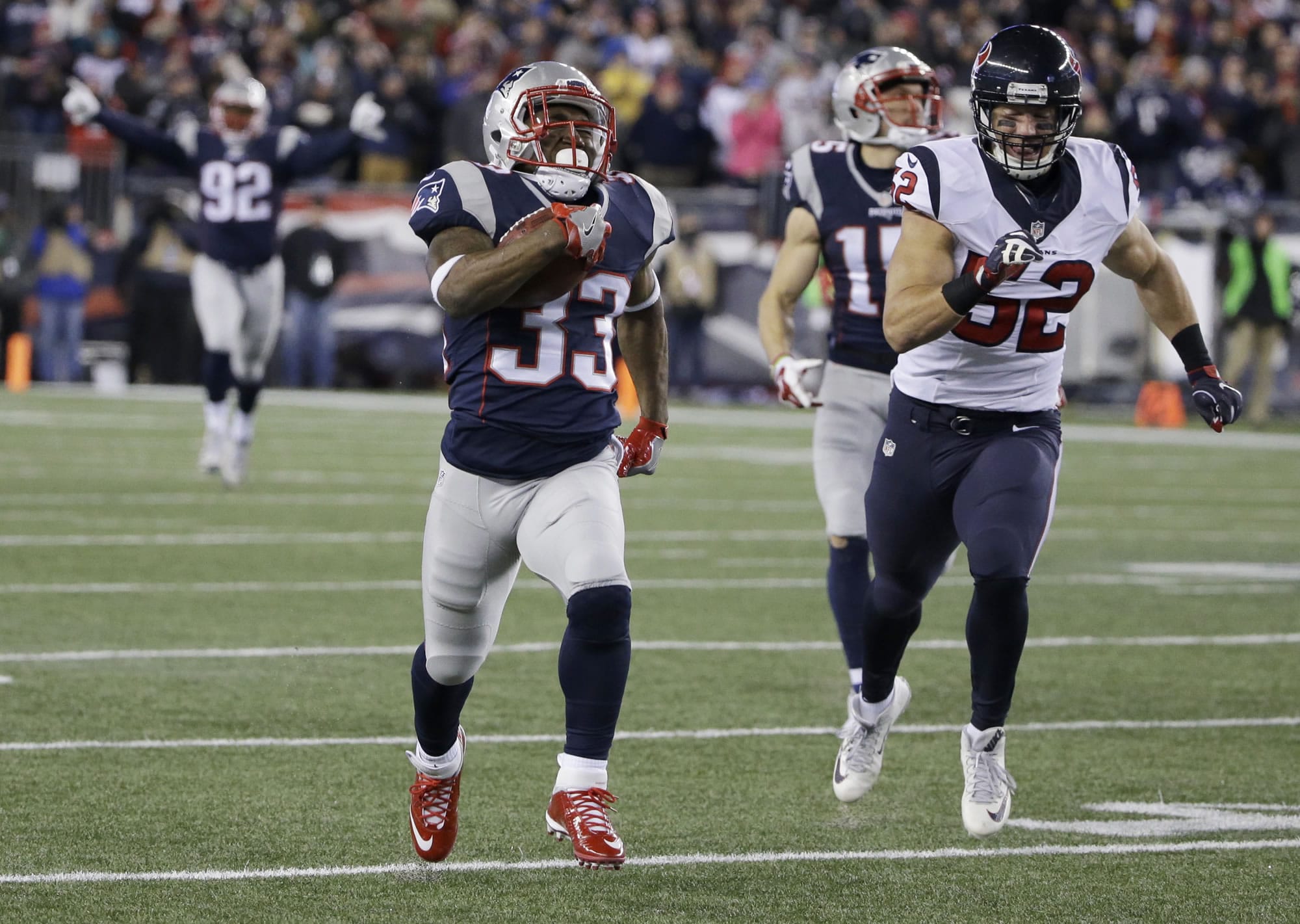 New England Patriots running back Dion Lewis (33) runs ahead of Houston Texans linebacker Brian Peters (52) for a touchdown during the first half of an NFL divisional playoff football game, Saturday, Jan. 14, 2017, in Foxborough, Mass.