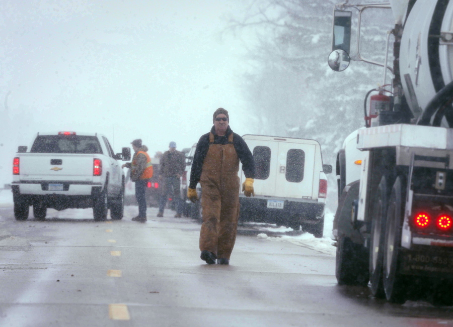Vehicles line the shoulder of a road as crews work to clean up after a pipeline leak in Worth County, north of Hanlontown Iowa, on Wednesday, Jan. 25, 2017. According to the Worth County Sheriff&#039;s Office, approximately 82,000 gallons of diesel fuel has leaked near a farm near the Minnesota border.