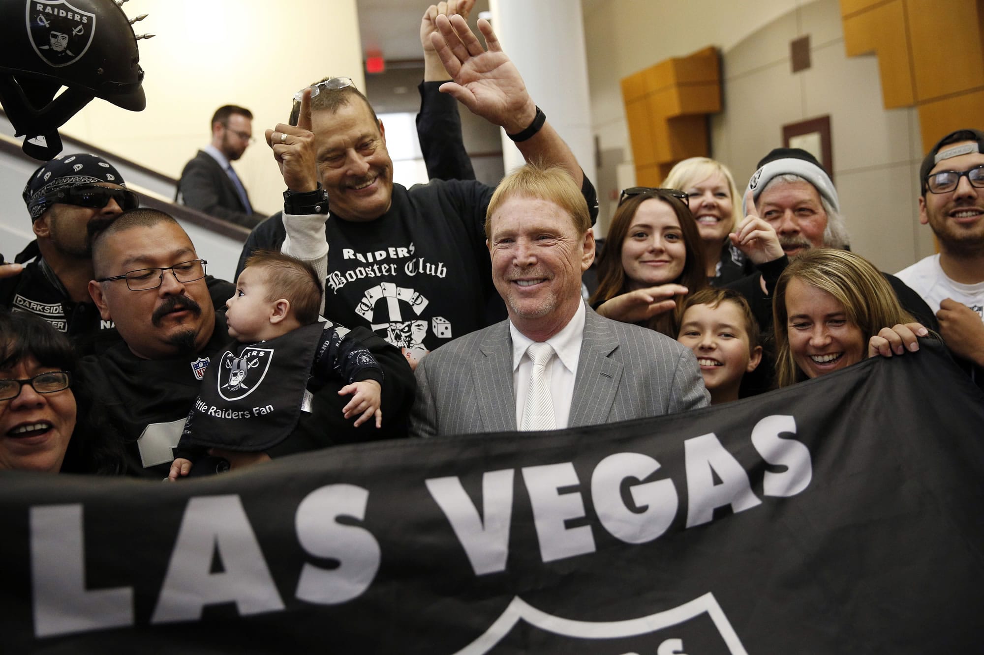 Oakland Raiders owner Mark Davis, center, meets with Raiders fans after speaking at a meeting of the Southern Nevada Tourism Infrastructure Committee in Las Vegas in April. The Raiders have filed paperwork to move to Las Vegas. Clark County Commission Chairman Steve Sisolak told The Associated Press on Thursday, Jan. 19, 2017,  that he spoke with the Raiders.