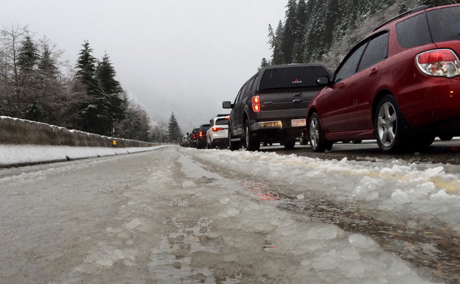 Vehicles traveling eastbound on Interstate 90 heading up Snoqualmie Pass are stopped in snow and slush during a road closure in December 2015. The recent deaths of two Washington State University students driving back to campus in Pullman after winter break have revived concerns about the safety of roadways leading to WSU.