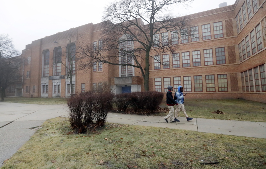 Students walk outside Pershing High School, Friday, Jan. 20, 2017, in Detroit. Pershing is one of up to 38 schools in Detroit and other urban communities that the state hopes to close, potentially affecting 18,000 students and marking the first time that the state could close traditional public schools explicitly for academic reasons. Despite the announcement, some schools likely will remain open.