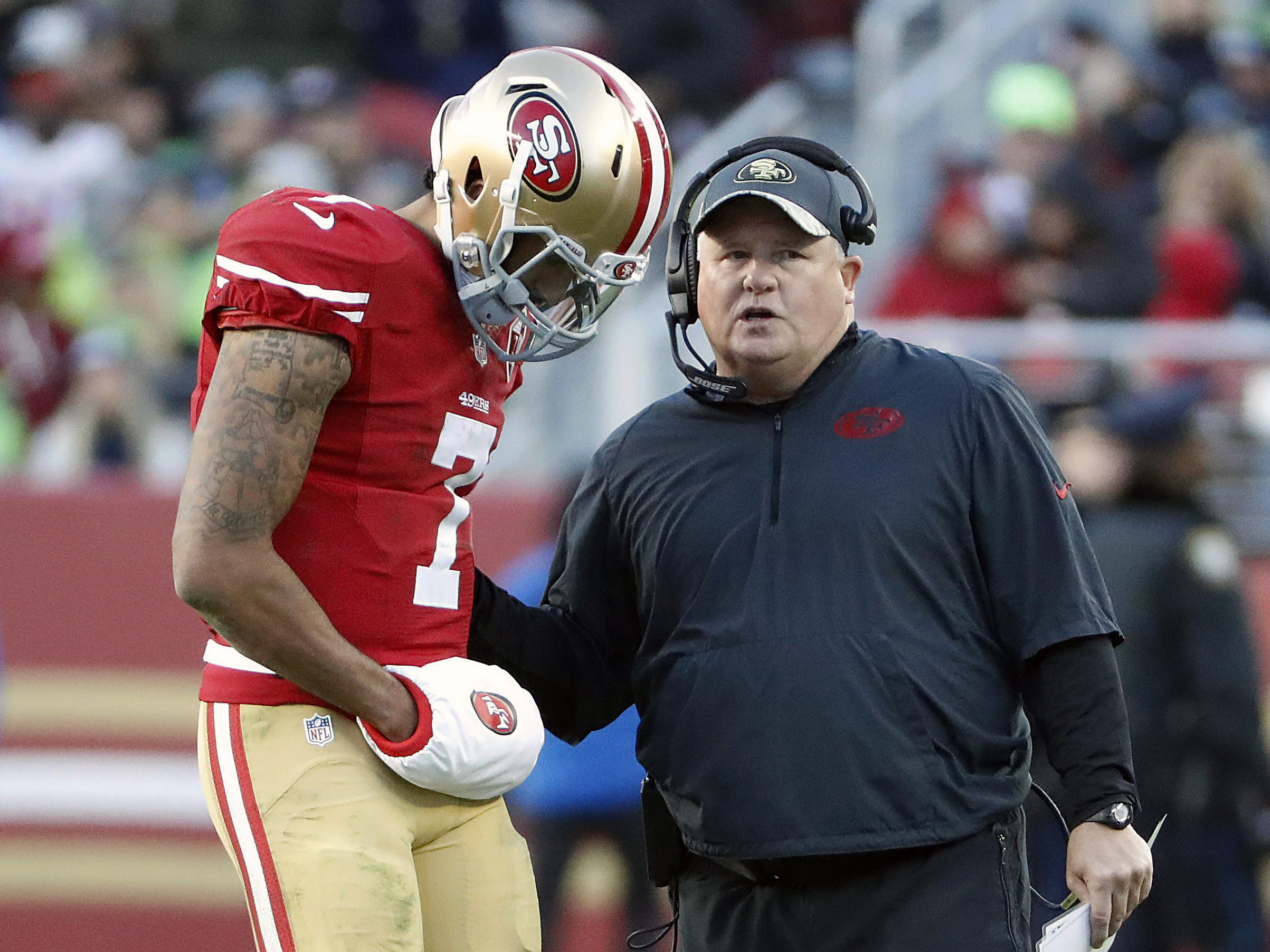 San Francisco 49ers quarterback Colin Kaepernick (7) talks with head coach Chip Kelly during the second half of an NFL football game against the Seattle Seahawks in Santa Clara, Calif., Sunday, Jan. 1, 2017.