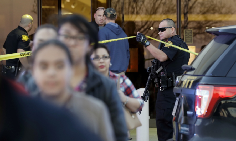 San Antonio police help shoppers exit the Rolling Oaks Mall in San Antonio after a deadly shooting Sunday (Eric Gay/Associated Press)