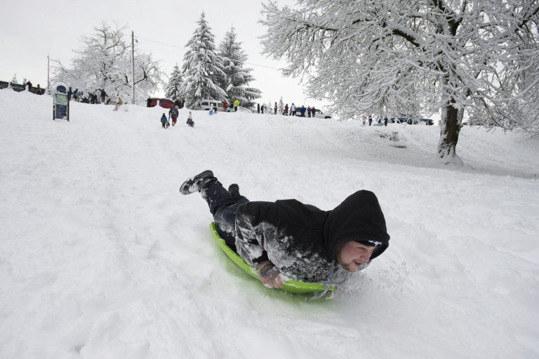 Maxx Barber of Vancouver slides head-first into the fun while joining kids of all ages at the sledding hill at Leverich Park on Wednesday afternoon. The West Minnehaha park was crowded with sledders -- and even the occasional snowboarder -- as snow blanketed Vancouver.