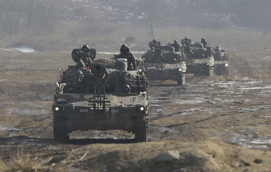 South Korean army K-55 self-propelled artillery vehicles move during a military exercise near the demilitarized zone between the two Koreas in Paju, South Korea.  (AP Photo/Ahn Young-joon.