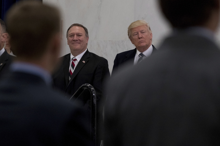 President Donald Trump, accompanied by CIA Director-designate Mike Pompeo, left, waits to speak Saturday at the Central Intelligence Agency in Langley, Va.