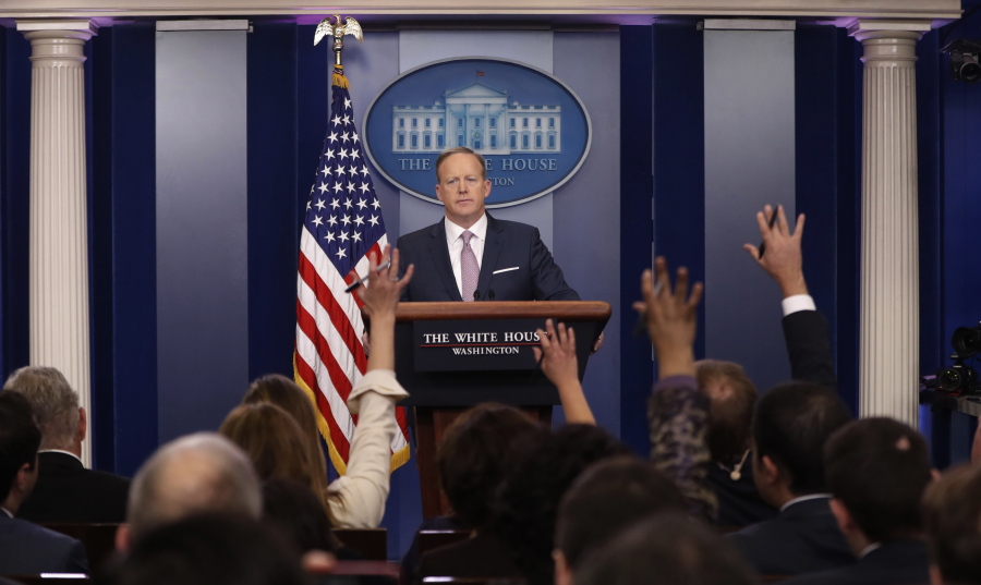 Reporters call on White House press Secretary Sean Spicer during the daily White House briefing Monday in the briefing room of the White House in Washington.