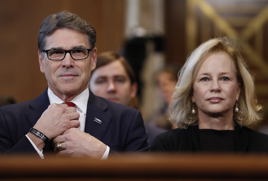 Energy Secretary-designate Rick Perry, accompanied by his wife Anita, straightens his tie prior testifying on Capitol Hill in Washington on Thursday at his confirmation hearing before the Senate Energy and Natural Resources Committee.