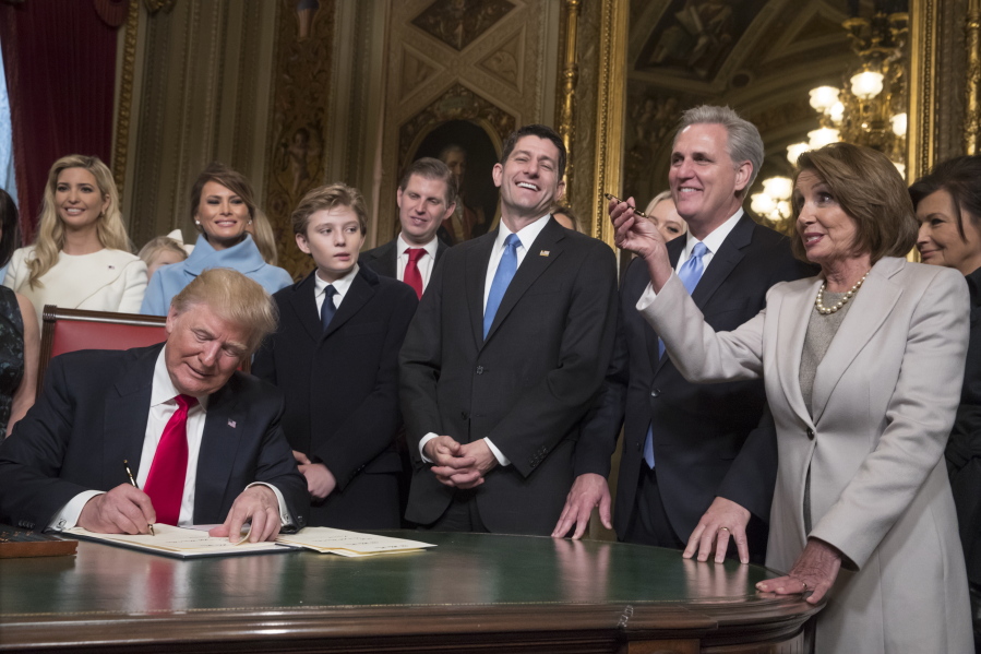 President Donald Trump is joined by the Congressional leadership and his family as he formally signs his cabinet nominations into law, in the President&#039;s Room of the Senate, at the Capitol in Washington, Friday, Jan. 20, 2017. From left behind Trump are, Ivanka Trump, Melania Trump, their son Barron Trump, Eric Trump, Speaker of the House Paul Ryan, R-Wis., Majority Leader Kevin McCarthy, D-Calif., and House Minority Leader Nancy Pelosi, D-Calif. (AP Photo/J. Scott Applewhite, Pool) (J.
