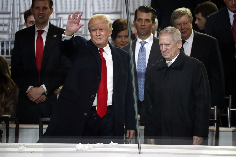 President Donald Trump, left, salutes with Defense Secretary-designate James Mattis as they view the 58th Presidential Inauguration parade for President Donald Trump in Washington. Friday, Jan.