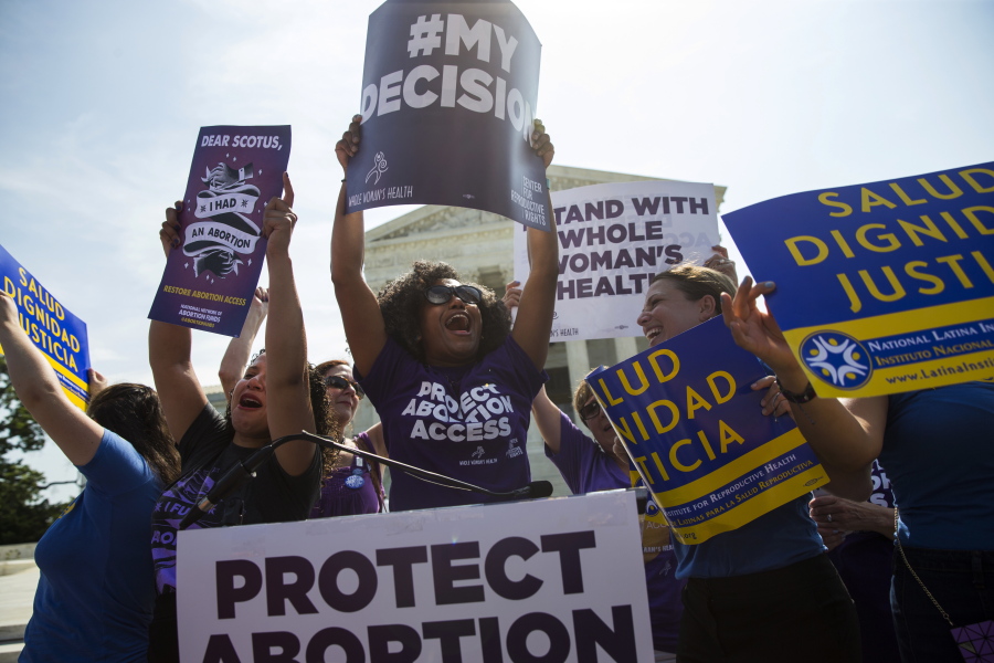 Pro-abortion rights activists celebrate during a rally at the Supreme Court in Washington. The tens of thousands of women flocking to Washington for a march on the day after Donald Trump&#039;s inauguration come packing a multitude of agendas, but are united in their loathing for Trump.