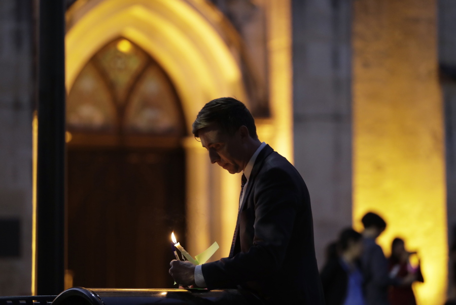 Jonathan Ryan writes a note of home as he joins other community activists in front of San Fernando Cathedral for a vigil on the eve of President-elect Donald Trump&#039;s inauguration, Thursday in San Antonio. The group gathered to show their support for immigration groups, women&#039;s groups, minorities, and others they fear may be harmed by new policies.