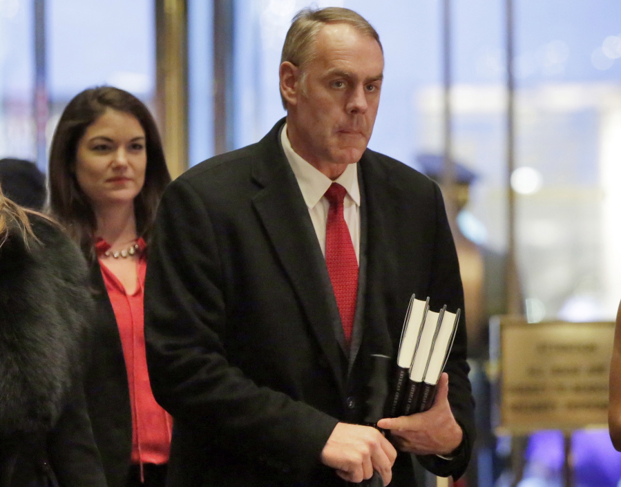 Interior Secretary-designate Rep. Ryan Zinke, right, R-Mont., arrives in Trump Tower, in New York on Dec. 12. Zinke says he would never sell, give away or transfer public lands, a crucial stance in his home state of Montana and the West, where access to hunting and fishing is considered sacrosanct.