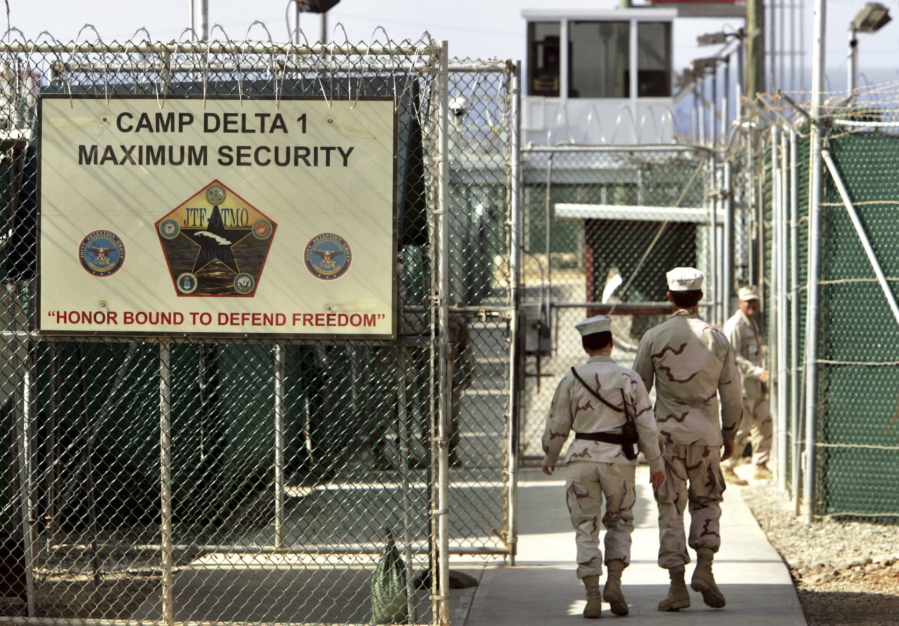 U.S. military guards walk within Camp Delta military-run prison, at the Guantanamo Bay US Naval Base, Cuba.