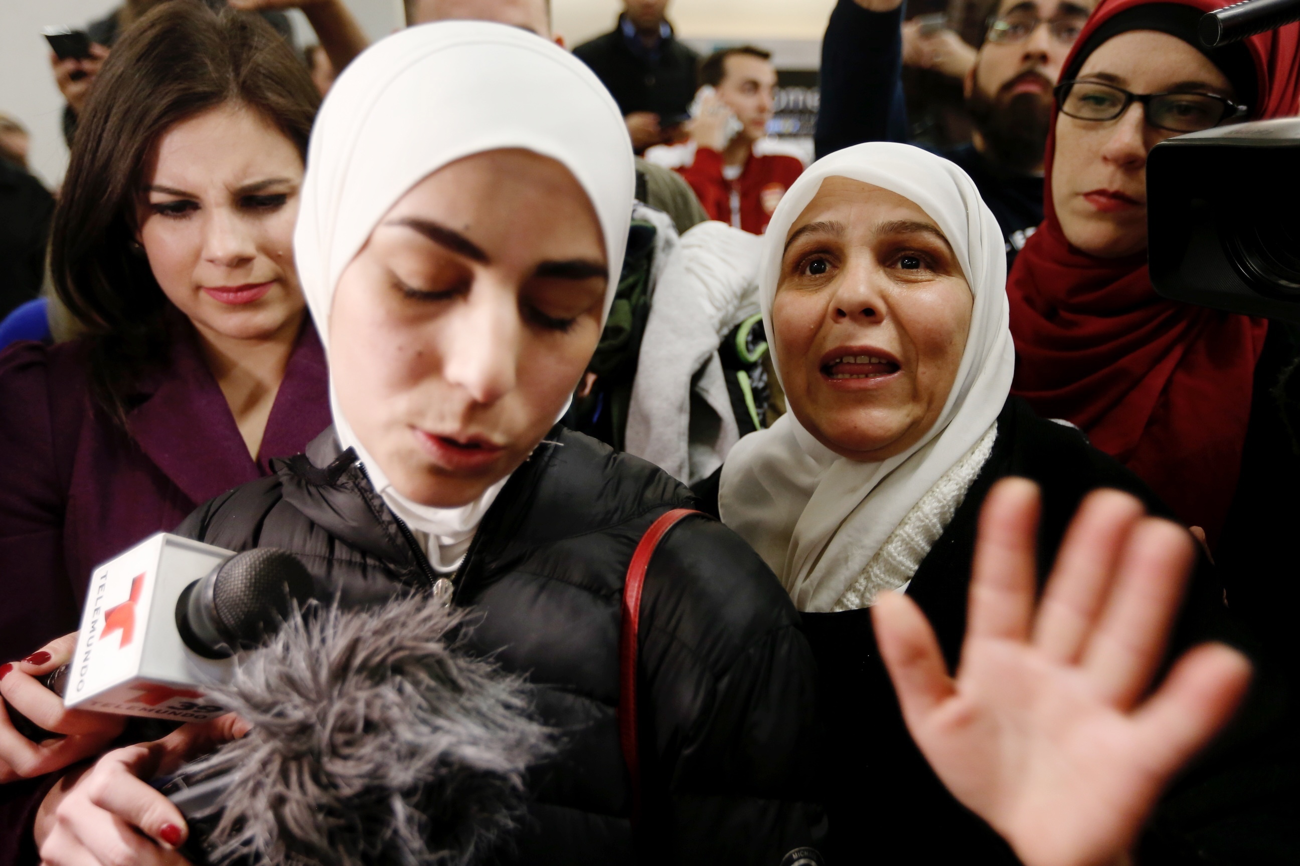 Mariam Yasin, left, translates for her mother Najah Alshamieh, 55, from Syria, after immigration authorities released Alshamieh at Dallas Fort-Worth airport, Saturday, Jan. 28, 2017. Alshamieh was held by immigration authorities after President Donald Trump signed an executive order barring muslims from certain countries from entering the Unties States.
