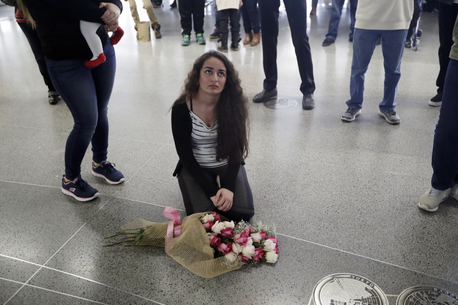 Reem Alrubaye, of Fremont, Calif., places flowers on the floor as she waits for her mother Mason Jadoaa to return from a visit to Baghdad, Iraq, at San Francisco International Airport, Monday, Jan. 30, 2017, in San Francisco. President Donald Trump&#039;s executive order bars citizens of seven predominantly Muslim-majority countries from entering the U.S.