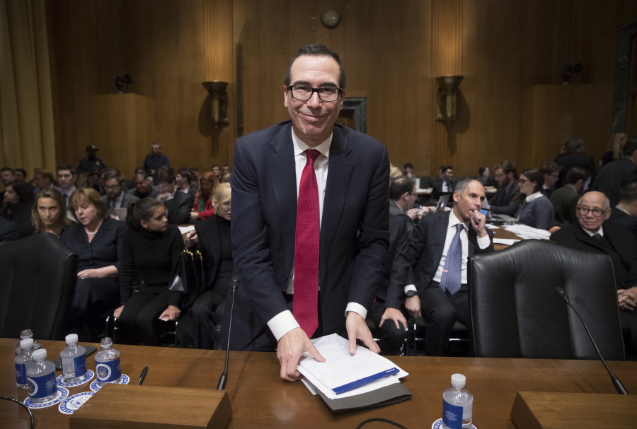 Treasury Secretary-designate Steven Mnuchin gathers his notes during a break Thursday after four hours of questions on Capitol Hill in Washington at his confirmation hearing before the Senate Finance Committee. (J.