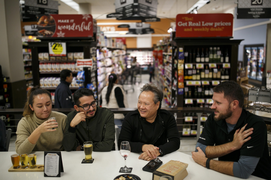 Carolyne Green, from left, Allan Reyes, Jerry Wong and Eric Holm socialize in November at a bar service inside the Ralphs on Ninth Street in downtown Los Angeles.