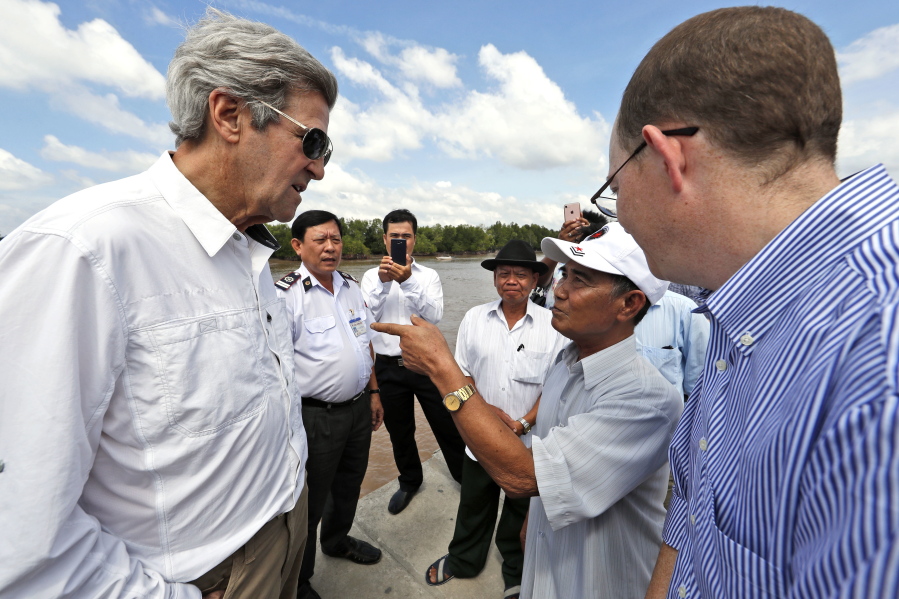 U.S. Secretary of State John Kerry, left, talks with Vo Van Tam, 70, second from right, who was a former Viet Cong guerrilla, who took part in the attack on Kerry&#039;s Swift Boat in Feb. 28, 1969, while on a tour of the region Saturday, Jan. 14, 2017 in the Mekong River Delta, Vietnam. Kerry once patrolled these waters on a U.S. naval gunboat and received the Silver Star for his actions.