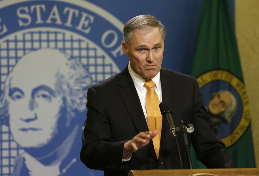 Washington Gov. Jay Inslee talks to reporters at the Capitol in Olympia in 2016.