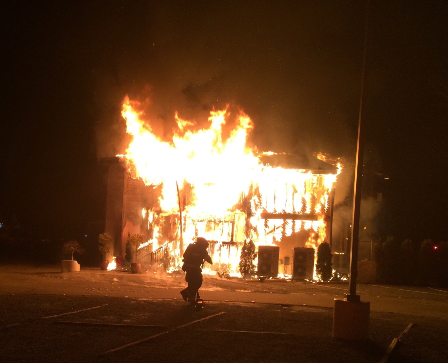 This photo provided by Bellevue, Wash., Fire Department, a fire burns at the Islamic Center of the Eastside in Bellevue, Wash., on Saturday, Jan. 14, 2017.  Police say a man is in custody after a suspicious fire severely damaged the mosque overnight.  Authorities say that as firefighters doused the flames, police found a 37-year-old man near the building and arrested him for investigation of arson. Police spokesman Seth Tyler says investigators believe the man is the sole suspect. His name was not immediately released. The mosque was unoccupied at the time and no injuries were reported.