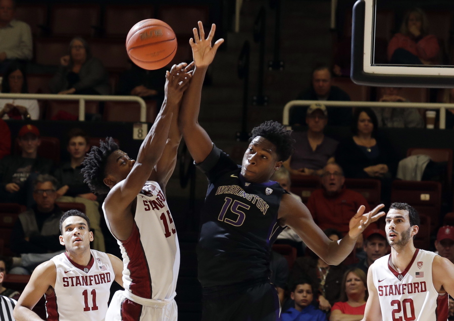 Washington forward Noah Dickerson, center right, battles for a rebound against Stanford guard Marcus Allen, center left, during the second half of an NCAA college basketball game Saturday, Jan. 14, 2017, in Stanford, Calif.