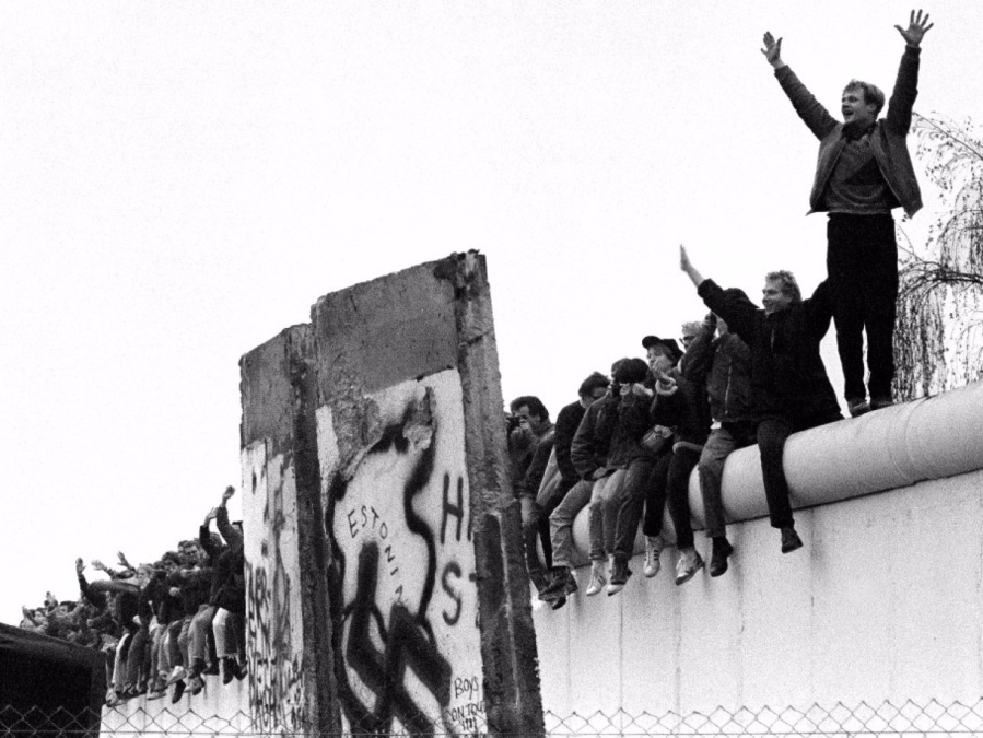 West Berliners rejoice atop the Berlin Wall as they look into East Berlin and all the East Berliners coming toward them at the wall opening at Potsdamer Platz on Nov. 12, 1989. (Richard A.