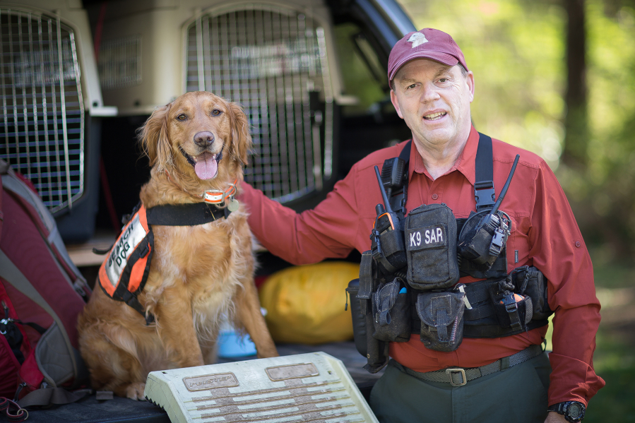 Robert Calkins and Ruger, his current search dog and pet. Calkins writes about Sierra, his dog of years ago, in search and rescue tales.