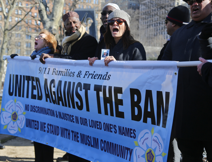 A group of Sept. 11 families and supporters rally against the travel ban Thursday in New York. Group spokesman John Sigmund, who lost his sister in the Sept. 11 attacks, said the group &quot;9/11 Families and Friends United Against the Ban&quot; came together two weeks ago to speak out against the ban.