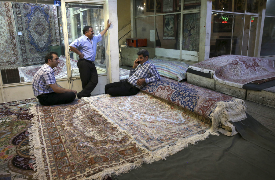 Iranian merchants wait for customers at a carpet market in 2015 in Tehran&#039;s old, main bazaar, in Iran. Bazaars such as this, along with mosques, museums and other sites, are on itineraries for sightseeing trips to Iran offered by tour companies.