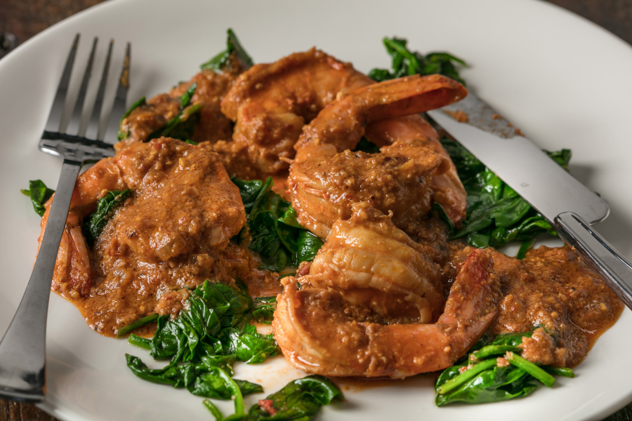 Shrimp Cooked in Romesco With Wilted Spinach (Goran Kosanovic for The Washington Post)