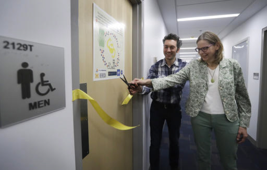 Abe Noe-Hays, director of research at the Vermont-based Rich Earth Institute, left, and Nancy Love, professor of civil and environmental engineering at the University of Michigan, cut the ribbon to a men&#039;s bathroom with a special toilet.